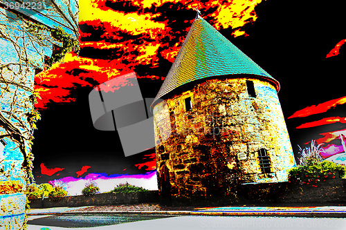 Image of old odd castle tower with dramatic sky