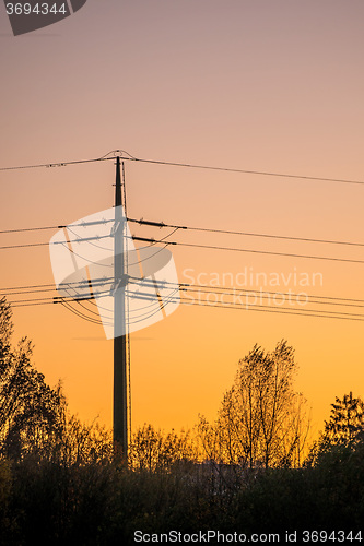 Image of sunset with afterglow and power mast