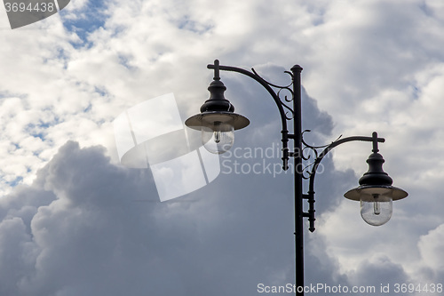 Image of Street lantern with dark cloudy sky