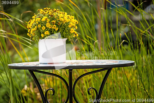 Image of Garden with desk and bouquet of flowers