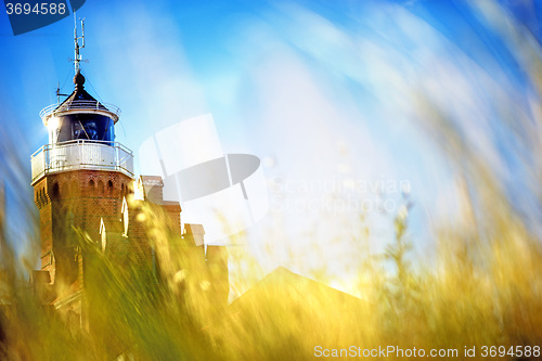 Image of beach grass with old lighthouse