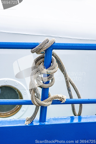 Image of rope on a blue reling of a trawler