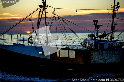 Image of sunset over the Baltic Sea with trawler
