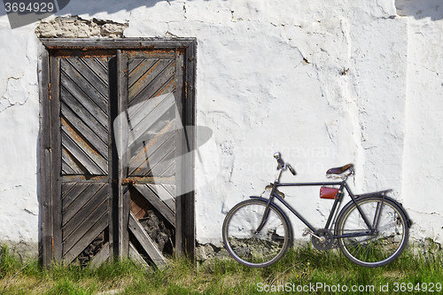 Image of Old wooden door and bicycle