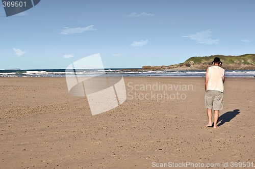 Image of man on phone on beach