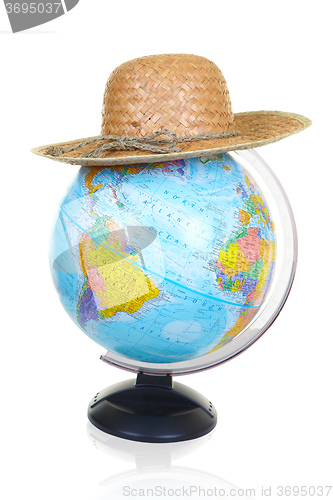 Image of The terrestrial globe and straw hat