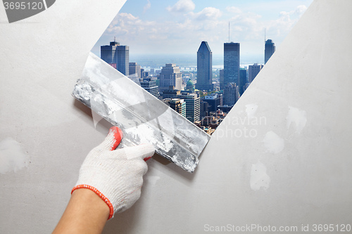 Image of Contractor Plasterer.  City and skyscraper