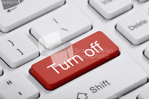 Image of Red key of the computer. Turn off