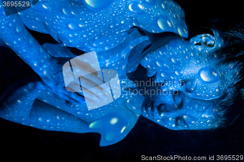 Image of The  body of woman with blue pattern and its reflection