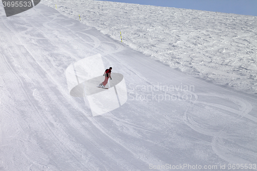 Image of Ski slope and snowboarder at cold day