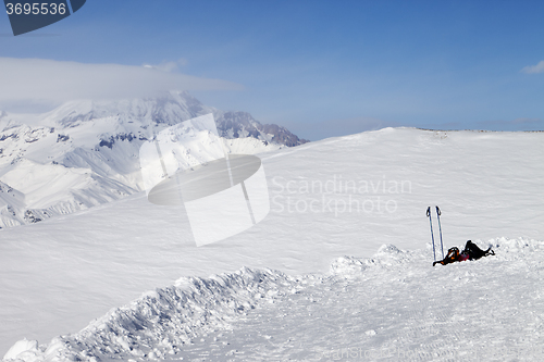 Image of Skiing and snowboarding equipment on slope at sunny day