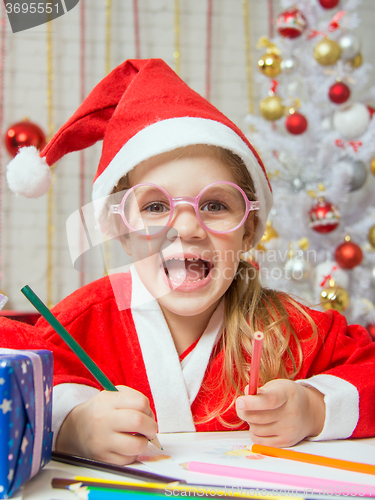 Image of Girl smiling happily drawing Gift card as a gift for Christmas