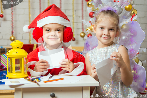 Image of Makeshift Santa Claus and fairy prepare congratulatory letters