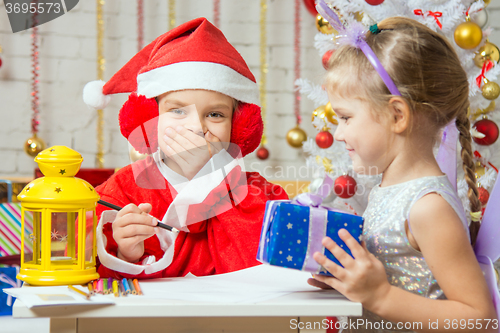 Image of Father Frost covered her mouth, the assistant is a fun fairy with a gift