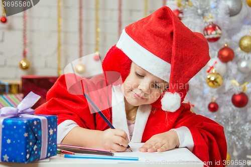 Image of Girl with enthusiasm writes congratulations Christmas card