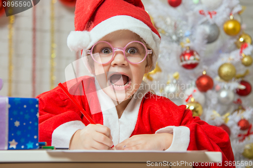 Image of Girl screams happily drawing Gift card as a gift for Christmas