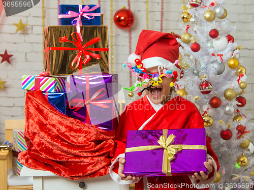 Image of Girl with fireworks rolling in from the eyes is a gift from bag of Christmas gifts