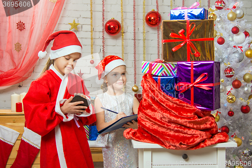 Image of Santa and helper checked bag with gifts