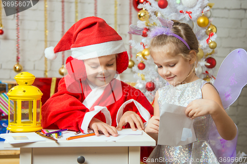 Image of Santa Claus and fairy helper packaged in envelopes greeting letter