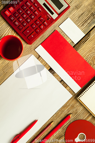 Image of The mockup on wooden background with red calculator