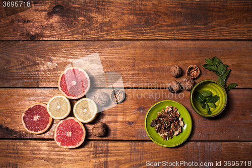 Image of Lemon and walnut on a wooden surface close up