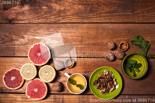 Image of Lemon and walnut on a wooden surface close up