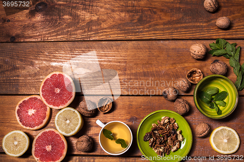 Image of Lemon and walnut on a wooden surface close up