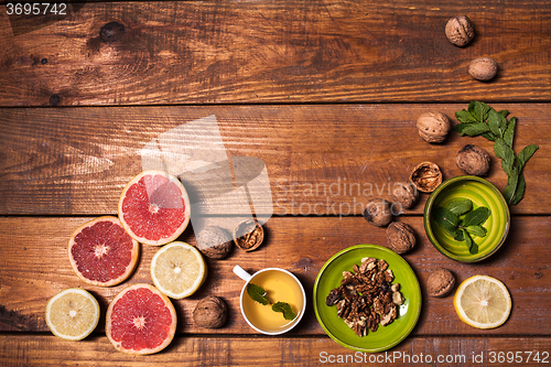 Image of Lemon and walnut on a wooden surface close up