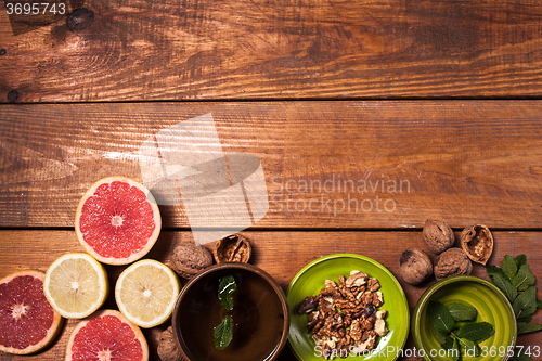 Image of Lemon and walnut on a wooden surface close up