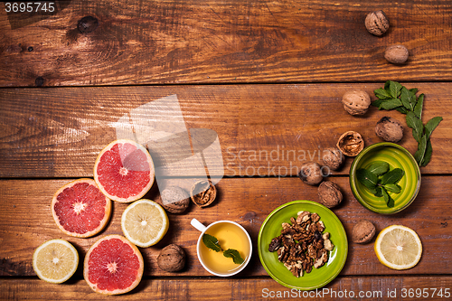 Image of Lemon and walnut on a wooden surface close up