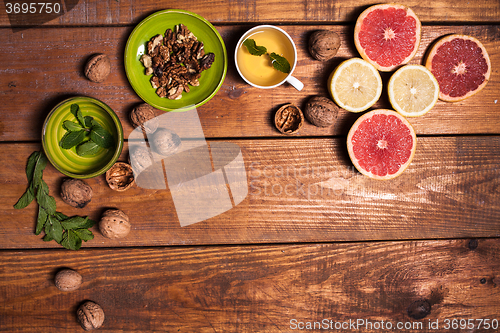 Image of Lemon and walnut on a wooden surface close up