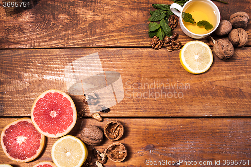 Image of Lemon and walnut on a wooden surface close up