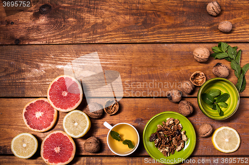 Image of Lemon and walnut on a wooden surface close up