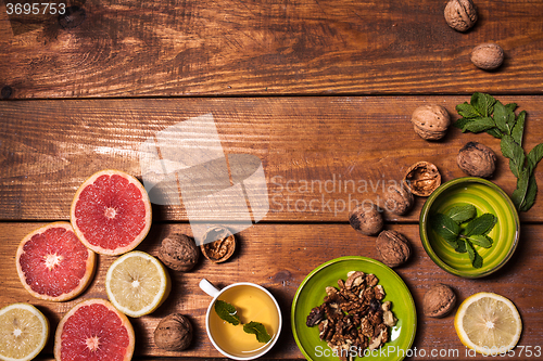 Image of Lemon and walnut on a wooden surface close up