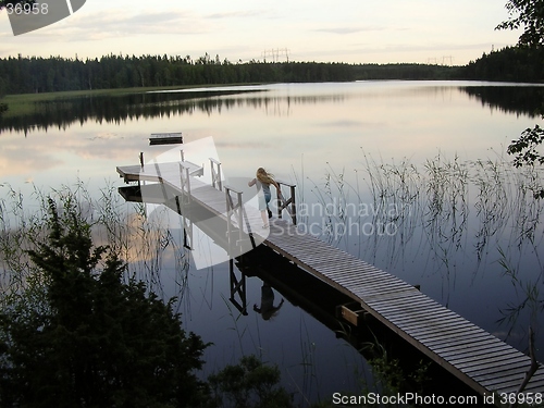 Image of Young girl on docking bridge