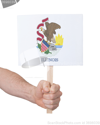 Image of Hand holding small card - Flag of Illinois