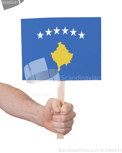 Image of Hand holding small card - Flag of Kosovo