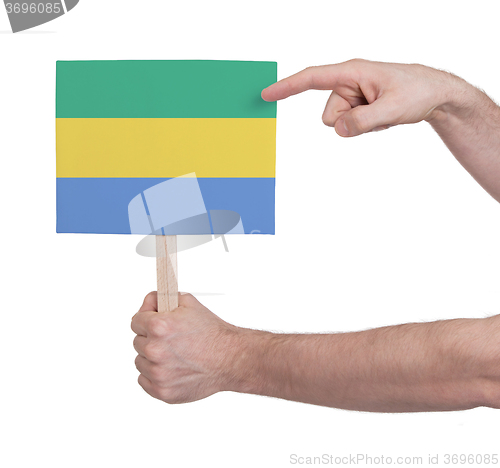 Image of Hand holding small card - Flag of Gabon