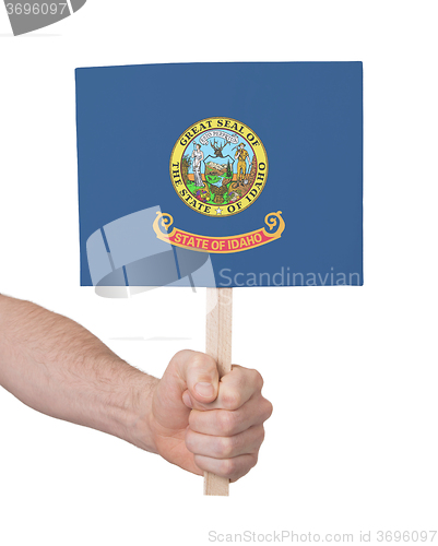 Image of Hand holding small card - Flag of Idaho