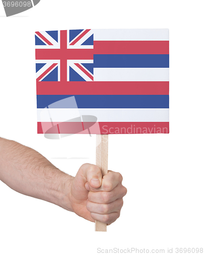 Image of Hand holding small card - Flag of Hawaii