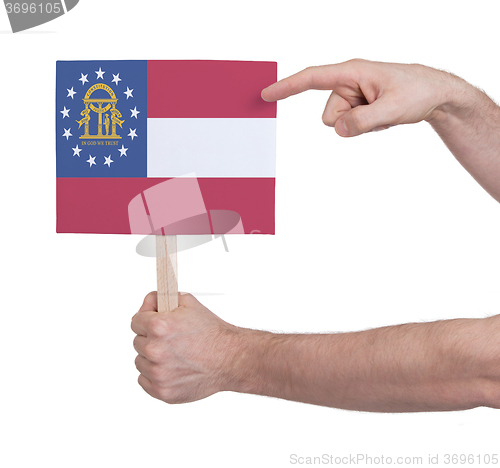 Image of Hand holding small card - Flag of Georgia