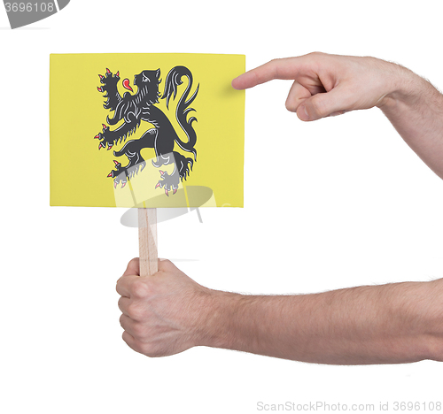 Image of Hand holding small card - Flag of Flanders