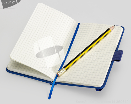 Image of open notebook and pencil