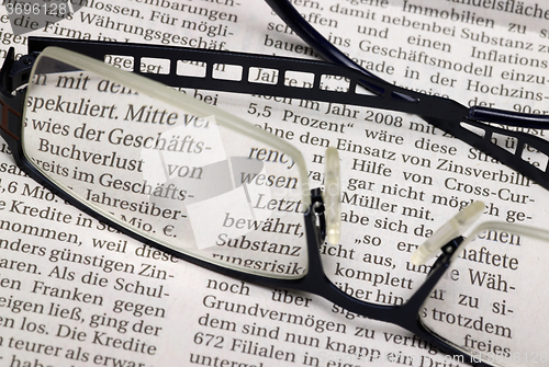 Image of glasses and newspaper