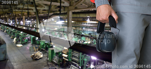 Image of Worker with protective headphone