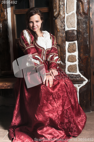 Image of Pretty woman in red dress in retro baroque style