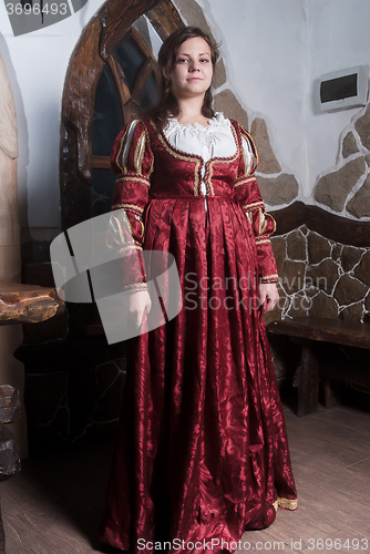Image of Attractive woman in red dress in retro baroque style