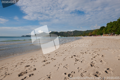 Image of Beach on tropical island. Clear blue water, sand, clouds. 