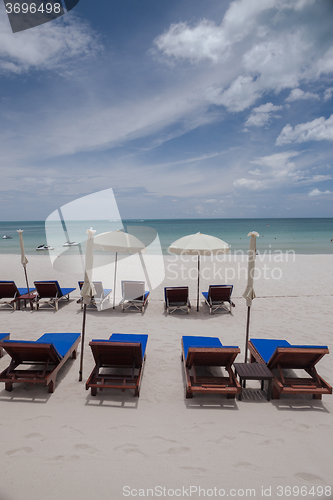 Image of Beach on tropical island. Clear blue water, sand, clouds. 