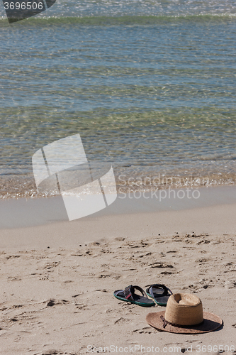 Image of Beach on tropical island. Clear blue water, sand, clouds. 